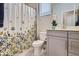 Charming bathroom with a floral shower curtain, white cabinets, and a clean, bright ambiance at 13460 Broad Wing Ave, Parker, CO 80134