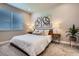Cozy bedroom with neutral decor, modern art, and lots of natural light at 13460 Broad Wing Ave, Parker, CO 80134