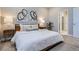 Inviting bedroom with cozy bed, stylish artwork, and an open doorway to the en-suite bathroom at 13460 Broad Wing Ave, Parker, CO 80134