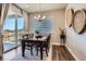 Bright dining room with modern chandelier and a sliding glass door offering backyard views at 13460 Broad Wing Ave, Parker, CO 80134