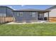 Rear exterior of the home with a well-manicured lawn, patio, and stylish gray siding at 13460 Broad Wing Ave, Parker, CO 80134