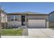 Charming single-Gathering home featuring a two-car garage, manicured lawn, and inviting front entrance at 13460 Broad Wing Ave, Parker, CO 80134
