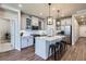 Stylish kitchen with white cabinets, stainless steel appliances, and an island with seating at 13460 Broad Wing Ave, Parker, CO 80134