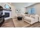 Beautiful living room with a fireplace, large sectional sofa, and contemporary decor at 13460 Broad Wing Ave, Parker, CO 80134