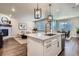 Open-concept living space featuring a kitchen island and a cozy living area at 13460 Broad Wing Ave, Parker, CO 80134