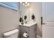 Elegant powder room featuring a modern vanity with a white countertop and decorative mirror at 13460 Broad Wing Ave, Parker, CO 80134