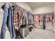 Spacious walk-in closet with ample hanging space, shelving, and room for luggage and shoe storage at 13460 Broad Wing Ave, Parker, CO 80134