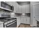 Modern kitchen with white cabinets and granite countertops at 8668 E 54Th Pl, Denver, CO 80238