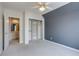 Bright bedroom with carpet, ceiling fan, and closet at 391 N Ogden St, Denver, CO 80218