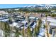 Scenic aerial view of a community with snow-covered roofs and lush trees, set against a backdrop of majestic mountains at 680 S Main St # 18, Breckenridge, CO 80424