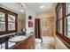 Well-lit bathroom features stone countertops and wooden frame window with natural lighting at 680 S Main St # 18, Breckenridge, CO 80424