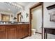 Spacious bathroom featuring double sinks, granite counters, and wooden cabinetry at 680 S Main St # 18, Breckenridge, CO 80424