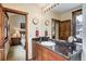 Bathroom featuring granite countertop, wooden trim, and natural lighting at 680 S Main St # 18, Breckenridge, CO 80424