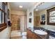Well-lit bathroom featuring a shower-tub combo, stone countertops, and wood-trimmed window at 680 S Main St # 18, Breckenridge, CO 80424