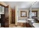 Well-lit bathroom with tiled shower, a soaking tub, and granite countertops at 680 S Main St # 18, Breckenridge, CO 80424