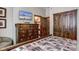 Comfortable bedroom features a dresser with TV and wood accents at 680 S Main St # 18, Breckenridge, CO 80424