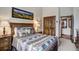 Bedroom with wood-framed bed, decor, and closet, filled with natural light at 680 S Main St # 18, Breckenridge, CO 80424
