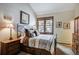 Comfortable bedroom featuring a metal bedframe, side tables and artwork at 680 S Main St # 18, Breckenridge, CO 80424