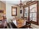 Cozy dining area with wood table and chairs with a view of snow covered trees at 680 S Main St # 18, Breckenridge, CO 80424