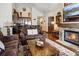 Inviting living room featuring a stone fireplace, wood floors, and adjacent kitchen at 680 S Main St # 18, Breckenridge, CO 80424
