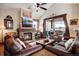 Cozy living room with a stone fireplace and comfortable leather seating with a view to the outside patio at 680 S Main St # 18, Breckenridge, CO 80424