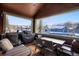 Covered patio with outdoor dining set and barbeque, showcasing views of nearby homes and the mountains at 680 S Main St # 18, Breckenridge, CO 80424