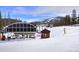 Snowy landscape featuring a ski lift with mountain views in the background on a clear day at 680 S Main St # 18, Breckenridge, CO 80424