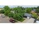 An aerial view of a home with a lush green yard and mature trees on a lovely street with other homes at 5170 Deephaven Ct, Denver, CO 80239