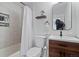 Modern bathroom with tiled shower, a wooden vanity and a decorative mirror at 5170 Deephaven Ct, Denver, CO 80239