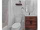 Modern bathroom with tiled shower, a wooden vanity and a decorative mirror at 5170 Deephaven Ct, Denver, CO 80239