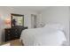 Cozy bedroom featuring a dark wood dresser and a comfortable bed at 5170 Deephaven Ct, Denver, CO 80239