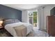 Bright bedroom with a large window/door leading to a backyard patio at 5170 Deephaven Ct, Denver, CO 80239