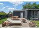 Cozy patio area with lounge chair, dining table, and a charming fire pit at 5170 Deephaven Ct, Denver, CO 80239