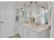 Bright bathroom featuring double sinks, vanity, large mirror and tiled floors at 10540 Tracewood Cir, Highlands Ranch, CO 80130