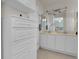 Well-lit bathroom with double vanity, storage cabinets, and modern fixtures at 10540 Tracewood Cir, Highlands Ranch, CO 80130