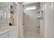 Updated bathroom features tile shower with bench, grab bar, and mosaic accent tile at 10540 Tracewood Cir, Highlands Ranch, CO 80130