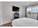 Inviting bedroom with a mounted TV, and a large window that provides natural light at 10540 Tracewood Cir, Highlands Ranch, CO 80130