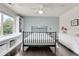 Bright bedroom with a metal frame bed, custom shelving, and a window seat at 10540 Tracewood Cir, Highlands Ranch, CO 80130