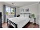A bedroom featuring a large window, dark hardwood floors, and a black metal bed frame at 10540 Tracewood Cir, Highlands Ranch, CO 80130