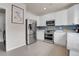 Modern kitchen with stainless steel appliances, white cabinetry, and tiled backsplash at 10540 Tracewood Cir, Highlands Ranch, CO 80130