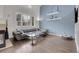 Living room features soaring ceilings, a comfortable gray sofa, and abundant natural light at 10540 Tracewood Cir, Highlands Ranch, CO 80130