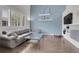 Bright and airy living room featuring a large sectional sofa, hardwood floors, and built-in shelving at 10540 Tracewood Cir, Highlands Ranch, CO 80130