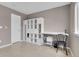 Neutral office with tile floors, built-in shelving, and bright window at 10540 Tracewood Cir, Highlands Ranch, CO 80130