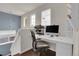 Bright home office featuring a white desk, comfortable chair, computer and shelves at 10540 Tracewood Cir, Highlands Ranch, CO 80130