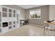 Room featuring tile floors, large window, desk, shelving, and storage for office at 10540 Tracewood Cir, Highlands Ranch, CO 80130
