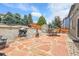 Spacious backyard featuring a stone patio, a shed and mature trees at 10540 Tracewood Cir, Highlands Ranch, CO 80130