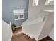 Stylish staircase featuring hardwood steps and a window that provides natural light at 10540 Tracewood Cir, Highlands Ranch, CO 80130
