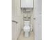 A view of the toilet, wall cabinet, and towel rack in the bathroom of the house at 10540 Tracewood Cir, Highlands Ranch, CO 80130