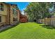 Beautiful backyard featuring a well-maintained lawn, wooden deck, and mature trees at 4901 W 103Rd Cir, Westminster, CO 80031