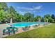 Relaxing community pool with picnic table and lounge chairs, perfect for summer enjoyment at 4901 W 103Rd Cir, Westminster, CO 80031
